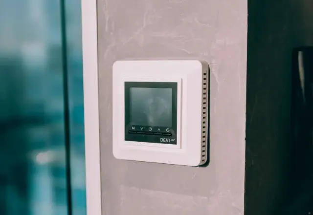 A wall mounted control system for air source heat pumps